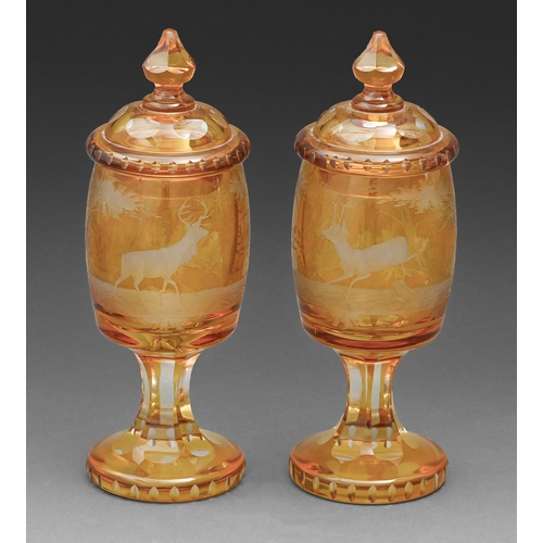 624 - A pair of Bohemian amber flashed and wheel engraved goblets and covers, 19th c or later, with a cont... 