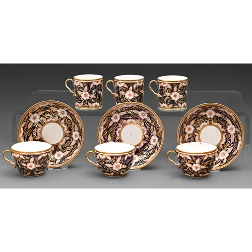 626 - A set of three English porcelain trios, c1800, decorated in red and gilt with stylised flowers on a ... 