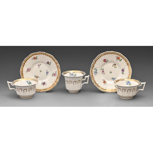 627 - A Rockingham trio and teacup and saucer, c1830-1842, of square handle shape, decorated in a floral b... 