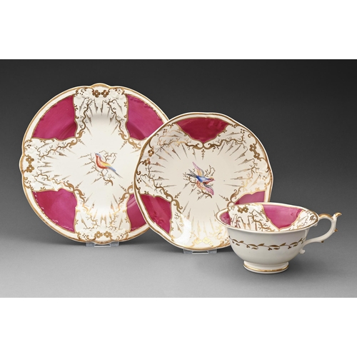 628 - A Rockingham breakfast cup, saucer and teapot stand, c1830-1842, of three spur handle shape, painted... 