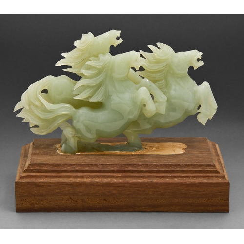 708 - A Chinese jade group of three horses, 20th c, wood base, 19cm h