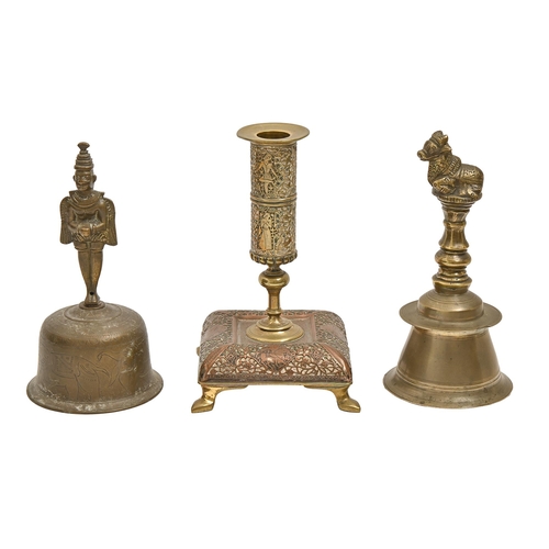 715 - Two English brass hand bells, late 19th c, 18 and 19cm h and a copper and brass candlestick (3)... 