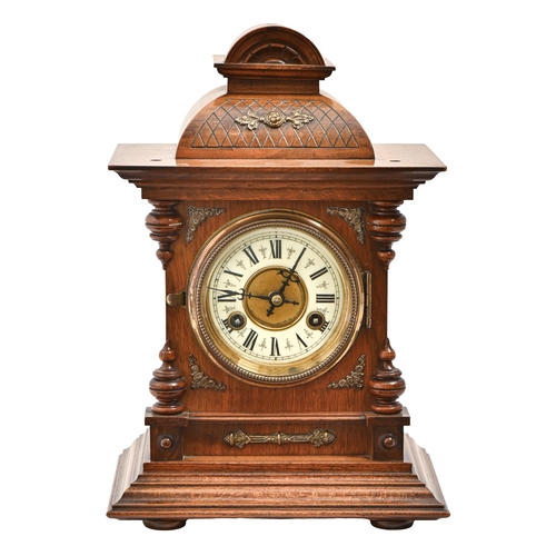 741 - A German walnut mantel clock, c1900, with primrose enamel chapter ring and gong striking movement, p... 