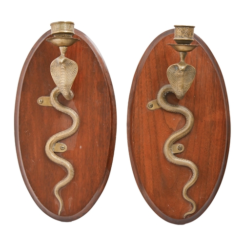 763 - A pair of Indian brass cobra wall sconces, mounted on contemporary oval walnut back plates, 38cm h. ... 