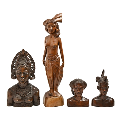 779 - Three South East Asian carved hardwood head sculptures and a statuette of a semi-naked woman, Bali, ... 