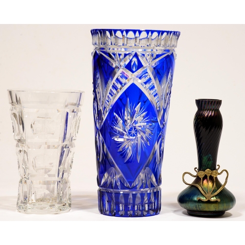 62 - A blue cased and cut glass vase, 30cm h, another, plain glass and a Bohemian iridescent glass vase, ... 