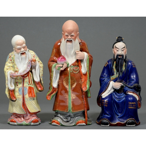 81 - Three  Chinese porcelain figures of immortals,  36cm and smaller