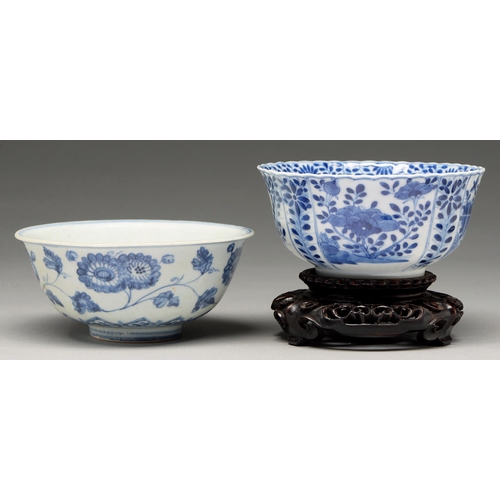 117 - A Chinese blue and white fluted bowl, 18th c, painted to the well with two flowering plants growing ... 