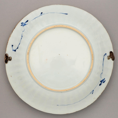 123 - A Chinese blue and white dish, Kangxi period, painted with peony and bamboo sprouting from hollow ro... 