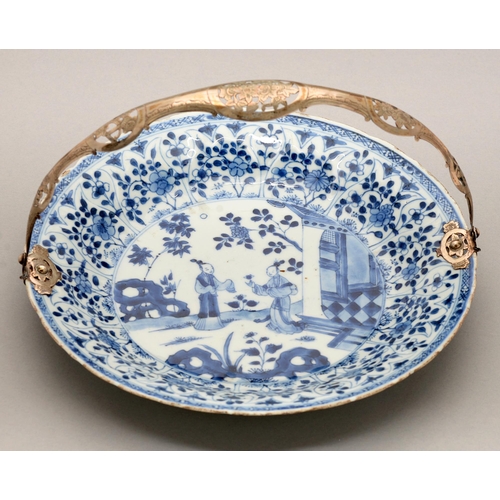 124 - A Chinese blue and white dish, Kangxi period, painted with two figures by a house and hollow rocks, ... 