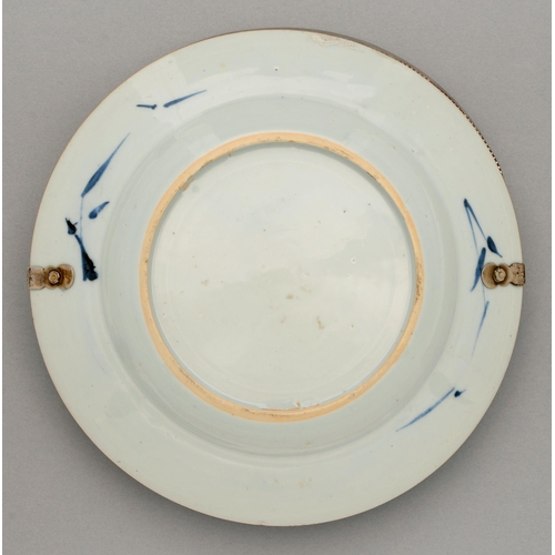 125 - A Chinese blue and white plate, 18th c, painted with a flowering plant, bamboo and fence on a scroll... 