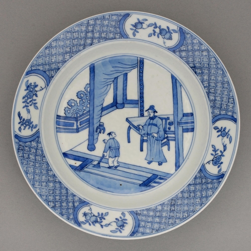 127 - A Chinese blue and white plate, Kangxi period, painted with a figure conversing with a house boy on ... 