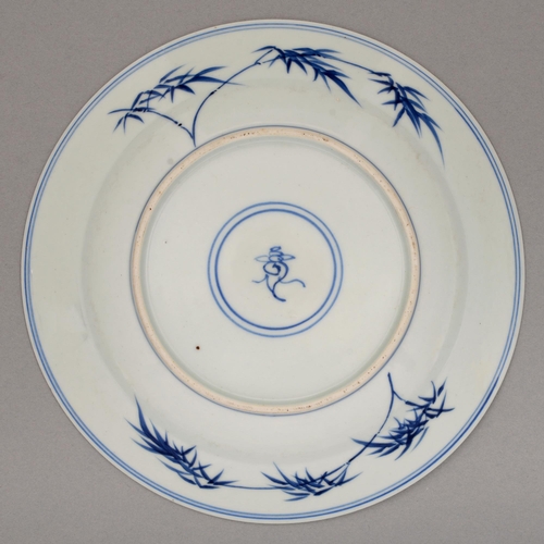 127 - A Chinese blue and white plate, Kangxi period, painted with a figure conversing with a house boy on ... 