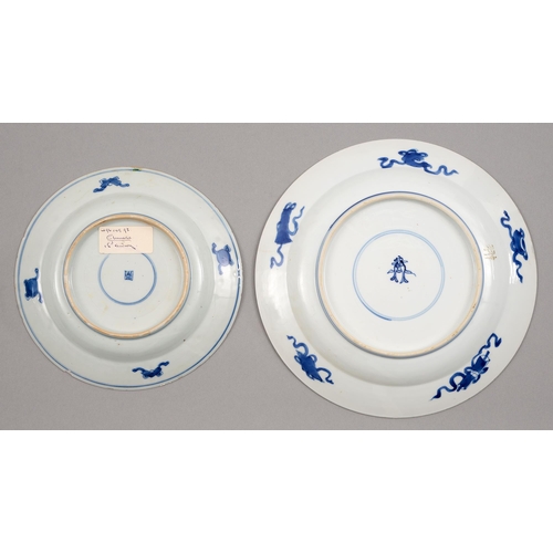 129 - Two graduated Chinese blue and white plates, 18th c, painted with dragon and carp rising from surgin... 