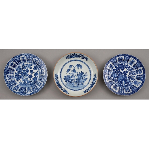 131 - Two Chinese blue and white plates, 18th c, painted with trees growing from hollow rocks, the border ... 