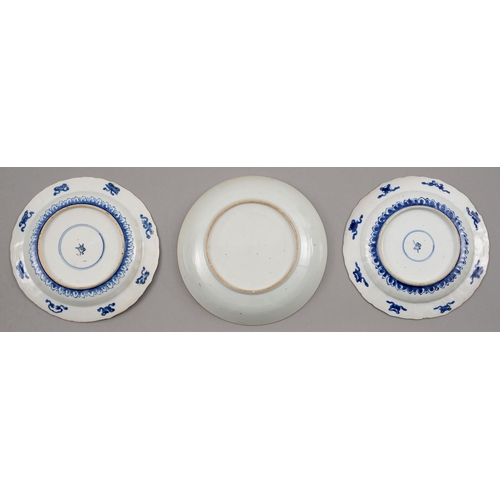 131 - Two Chinese blue and white plates, 18th c, painted with trees growing from hollow rocks, the border ... 