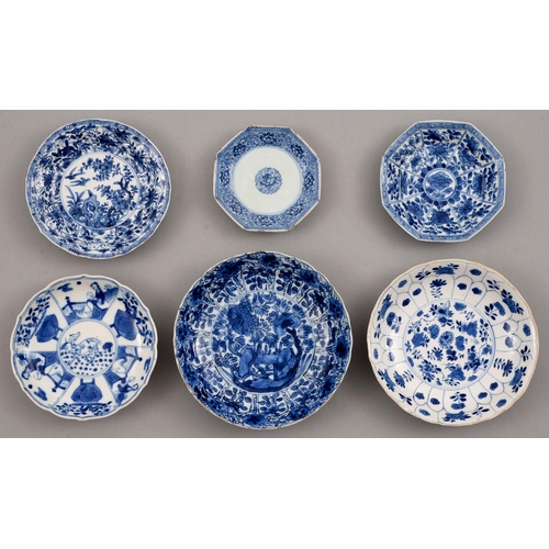 132 - Six Chinese blue and white saucers, Kangxi period, one petal-moulded, each painted with a different ... 