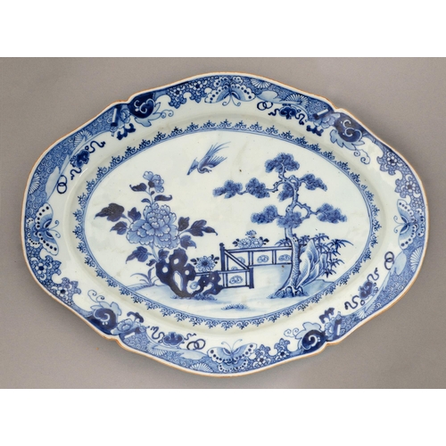 139 - A Chinese blue and white dish, 18th / early 19th c, painted with a pine tree and tree peony before a... 