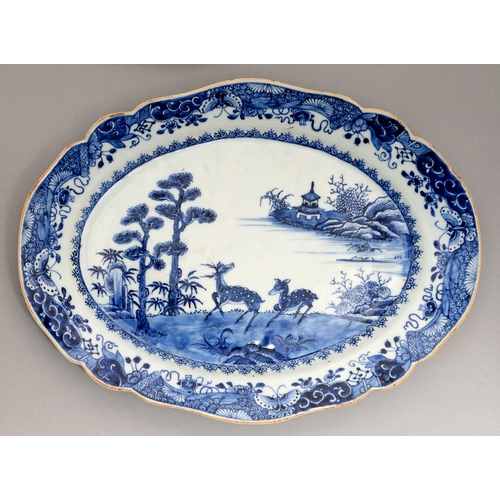 140 - A Chinese blue and white dish, 18th c, painted with a river scene with two prominent antelope and tw... 