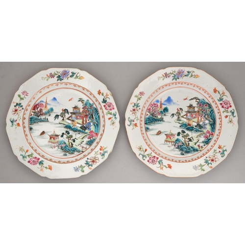 151 - A pair of Chinese famille rose plates, c1770, enamelled with a river scene in gilt spearhead cavetto... 