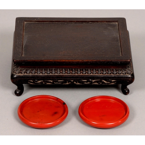 181 - A pair of Chinese plain round cinnabar lacquer stands, 20th c, 87mm diam and a Chinese hardwood low ... 