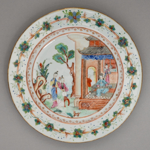 186 - A Chinese famille rose plate, 18th c, enamelled with figures in a building or garden amidst flowerin... 