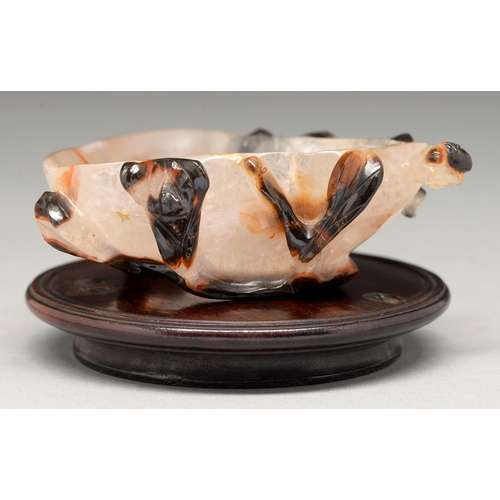 205 - A Chinese carved agate brush washer, 19th c or later, of asymmetrical form, 85mm l