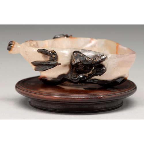 205 - A Chinese carved agate brush washer, 19th c or later, of asymmetrical form, 85mm l