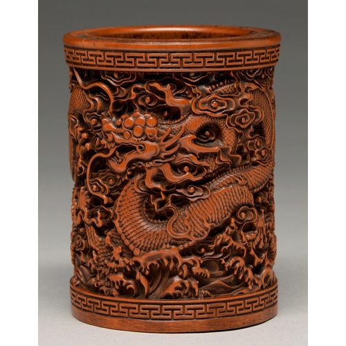 207 - A Chinese bamboo brush pot, 20th c, carved with dragons between key fret borders, 12cm h... 