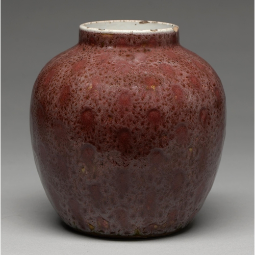 224 - A Chinese flambe glazed jar, Qing dynasty, covered in a mottled uneven dull red glaze of orange peel... 