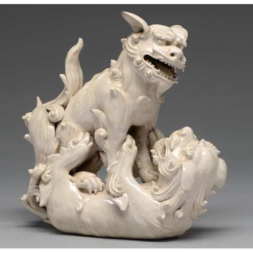 231 - A Chinese glazed porcelain group of fighting lion dogs, 19th c or later, 28cm h, wood stand carved w... 