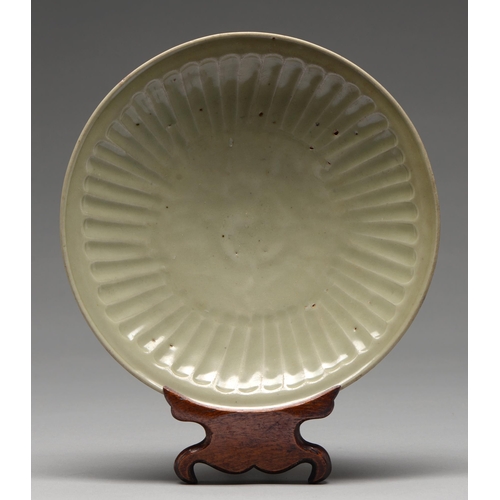 234 - A Swatow Ware dish, Ming dynasty, of fluted form, unglazed inside the foot ring, 28cm diam  Provenan... 