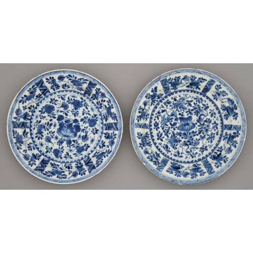 236 - Two Chinese blue and white plates, Kangxi period, painted with flowers and birds in panelled border ... 