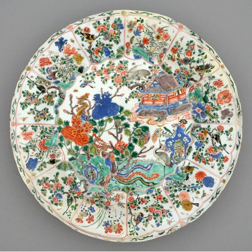 252 - A Chinese famille verte dish, Kangxi period, enamelled with temple, phoenix, cranes and flowering pl... 