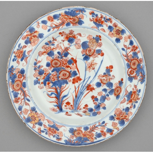 255 - A Chinese Imari plate, 18th c, painted with three clumps of flowering plants bordered by trailing fl... 