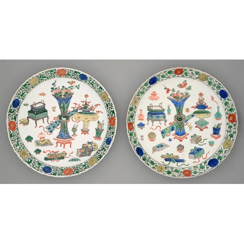 257 - Two Chinese wucai dishes, Kangxi period, painted with sacrificial vessels and auspicious emblems bor... 