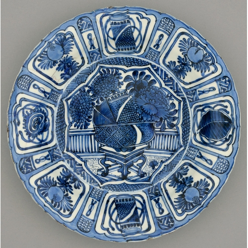 259 - A Chinese Kraak porcelain blue and white dish, c1630-1650, painted to the centre with a flower fille... 