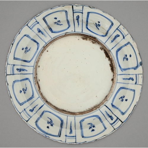 259 - A Chinese Kraak porcelain blue and white dish, c1630-1650, painted to the centre with a flower fille... 