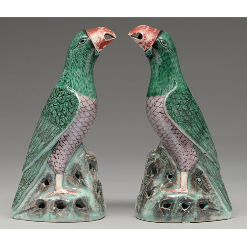 262 - A pair of Chinese glazed biscuit models of parrots, 19th c in Kangxi style, with black eye and green... 