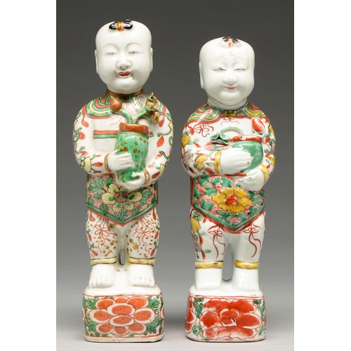 264 - Two Chinese famille verte figures of boys, Kangxi period, each holding a pot of lotus, 27 and 29cm h... 