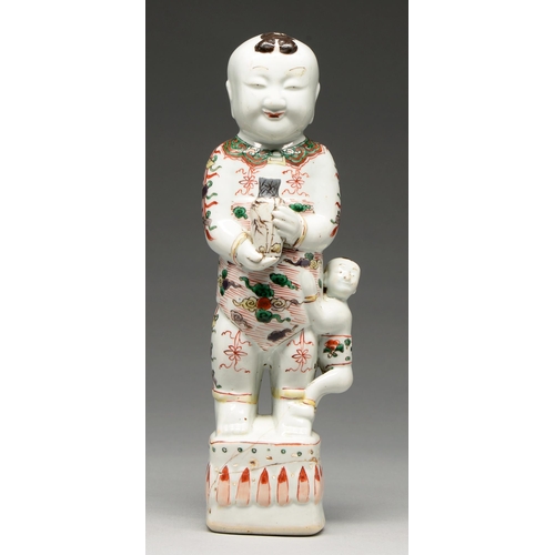 266 - A Chinese famille verte of a boy, Kangxi period, holding a vase, a smaller child at his side, 33cm h... 