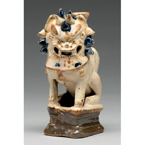 270 - A Chinese cream, cobalt and manganese glazed tileworks dog of Fo incense burner, 18th c, 16cm h... 