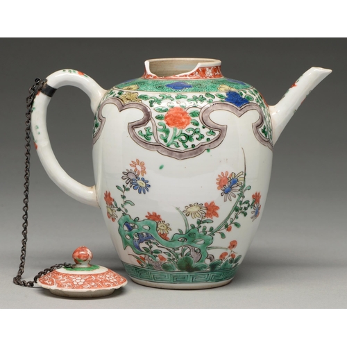 285 - A Chinese famille verte teapot and cover, Kangxi period, enamelled with flowers sprouting from hollo... 