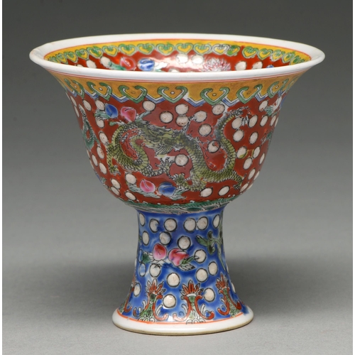 296 - A Chinese famille rose stem cup, 19th c or later, the bell shaped bowl enamelled with dragons on a r... 