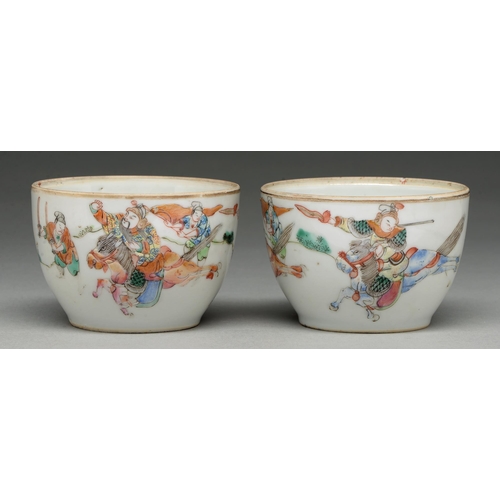 299 - A pair of Chinese famille rose bowls, 19th c, enamelled with mounted warriors and attendants, the gl... 