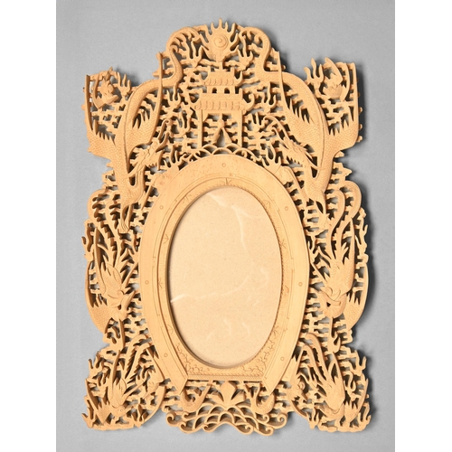 321 - A Chinese carved and pierced wood photograph frame, c1900, the oval aperture framed by a horseshoe s... 