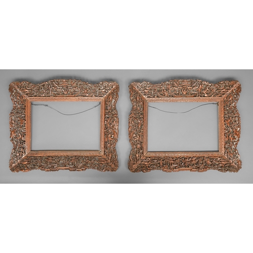 322 - A pair of Chinese pierced, carved and stained wood frames, late 19th / early 20th c, with acrobats, ... 