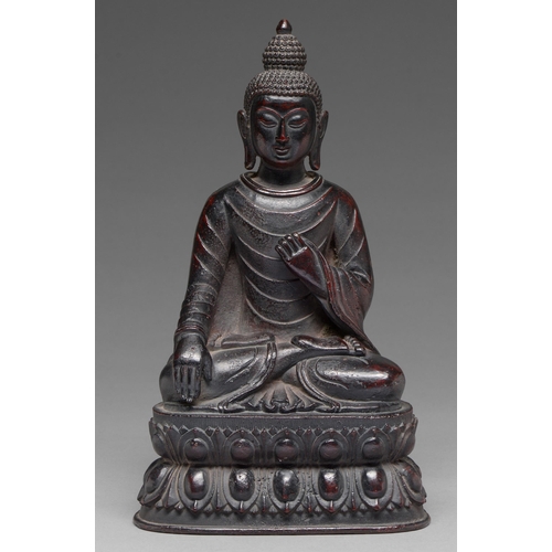 324 - A Chinese bronze figure of Shakyamuni Buddha, 18th c or later,   seated in Ghumisparsha mudra, on do... 