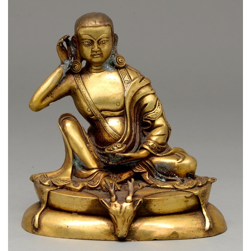 332 - A Tibetan gilt lacquered bronze figure of  Milarepa Siddha Buddha, 19th / 20th c, the base with deer... 