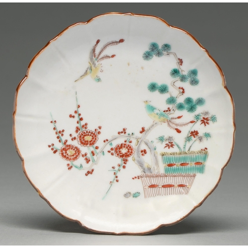 343 - A Chinese fluted saucer with Kakiemon-style decoration, 18th c, enamelled with a prunus and pine gro... 